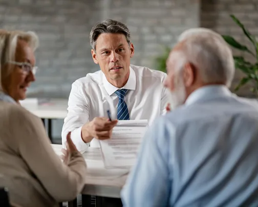 doctor speaking with old couple